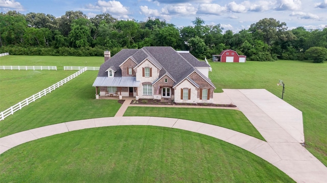 1020 High Meadow Dr, Mount Vernon, TX 75457 - view of front of house featuring an outdoor structure, a chimney, stone siding, and brick siding