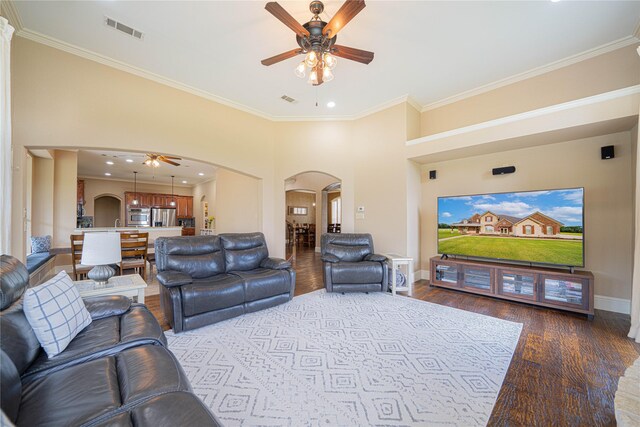 1020 High Meadow Dr, Mount Vernon, TX 75457 - living area with arched walkways, ceiling fan, ornamental molding, wood finished floors, and baseboards