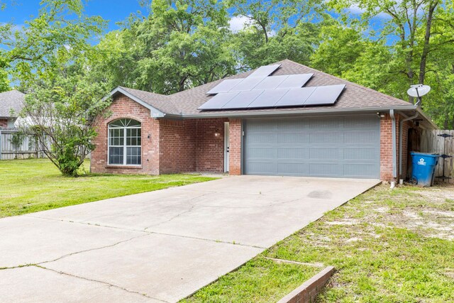 15630 Brittain Ct, Lindale, TX 75771 - single story home featuring an attached garage, solar panels, brick siding, concrete driveway, and a shingled roof