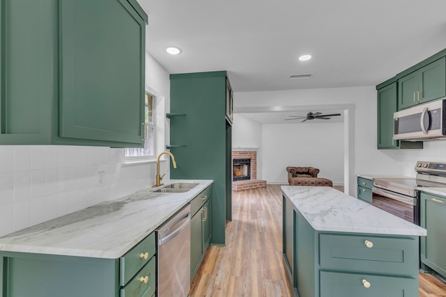 15630 Brittain Ct, Lindale, TX 75771 - kitchen featuring appliances with stainless steel finishes, green cabinetry, ceiling fan, a sink, and recessed lighting