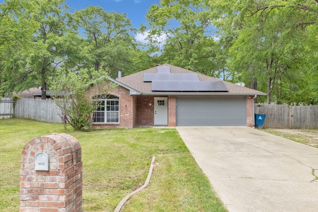 15630 Brittain Ct, Lindale, TX 75771 - view of front of property featuring a shingled roof, brick siding, an attached garage, roof mounted solar panels, and driveway
