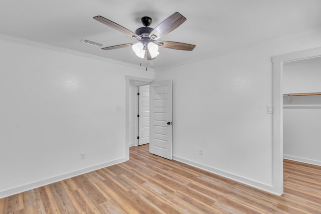 15630 Brittain Ct, Lindale, TX 75771 - unfurnished bedroom with light wood-type flooring, ornamental molding, baseboards, a closet, and a walk in closet