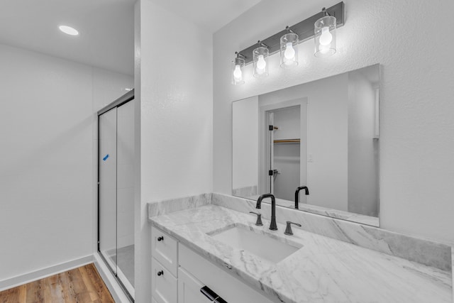 15630 Brittain Ct, Lindale, TX 75771 - bathroom featuring a stall shower, vanity, and wood finished floors