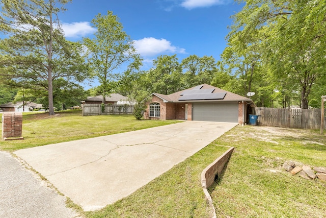 15630 Brittain Ct, Lindale, TX 75771 - view of front of home featuring solar panels, a garage, concrete driveway, and brick siding