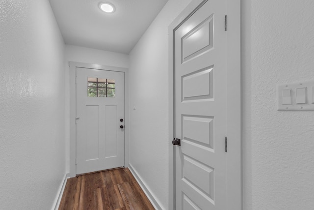 15630 Brittain Ct, Lindale, TX 75771 - doorway to outside featuring dark wood-style flooring, baseboards, and a textured wall