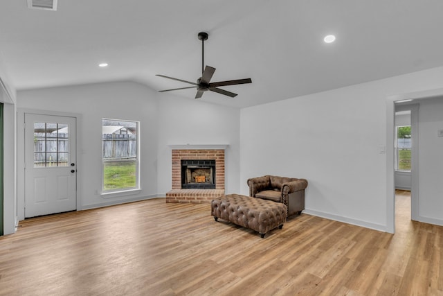 15630 Brittain Ct, Lindale, TX 75771 - sitting room with ceiling fan, lofted ceiling, healthy amount of natural light, light wood-style floors, and a brick fireplace