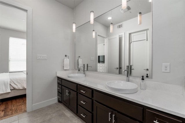 5816 Lindell Ave Unit 3, Dallas, TX 75206 - full bathroom with baseboards, double vanity, ensuite bath, and tile patterned flooring
