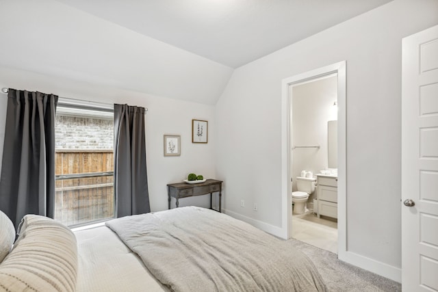 1108 Sandgate Dr, Forney, TX 75126 - carpeted bedroom featuring lofted ceiling, baseboards, and ensuite bath