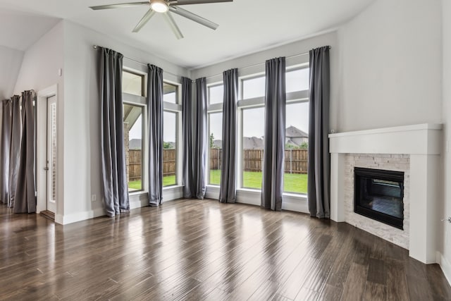 1108 Sandgate Dr, Forney, TX 75126 - unfurnished living room with ceiling fan, a stone fireplace, wood finished floors, and baseboards