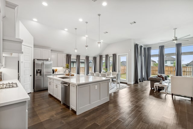1108 Sandgate Dr, Forney, TX 75126 - kitchen featuring appliances with stainless steel finishes, lofted ceiling, a sink, light countertops, and a center island with sink