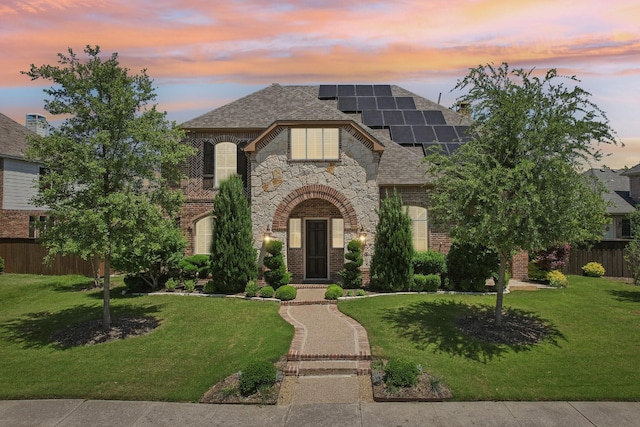 2026 Spindletop Trl, Frisco, TX 75033 - french provincial home featuring roof mounted solar panels, brick siding, stone siding, and roof with shingles
