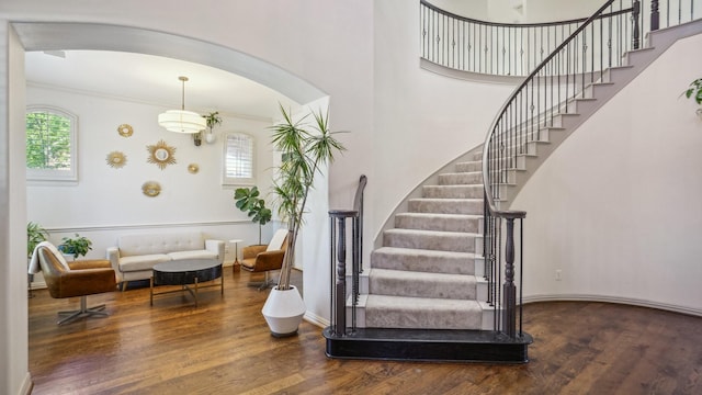2026 Spindletop Trl, Frisco, TX 75033 - staircase with arched walkways, wood finished floors, crown molding, baseboards, and a high ceiling