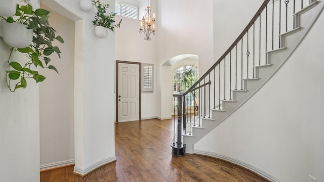 2026 Spindletop Trl, Frisco, TX 75033 - entrance foyer featuring arched walkways, wood finished floors, stairway, a towering ceiling, and baseboards