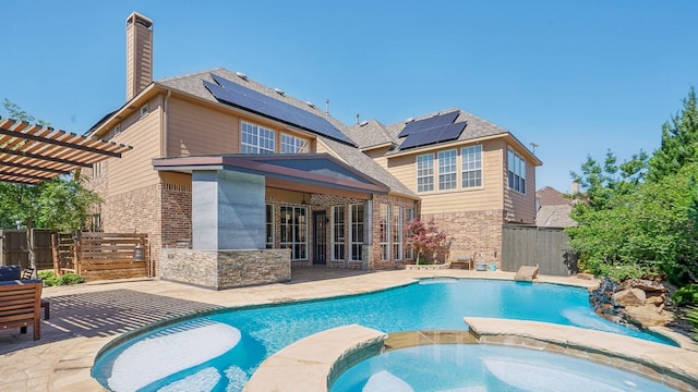 2026 Spindletop Trl, Frisco, TX 75033 - rear view of house featuring roof mounted solar panels, brick siding, a pergola, and a patio