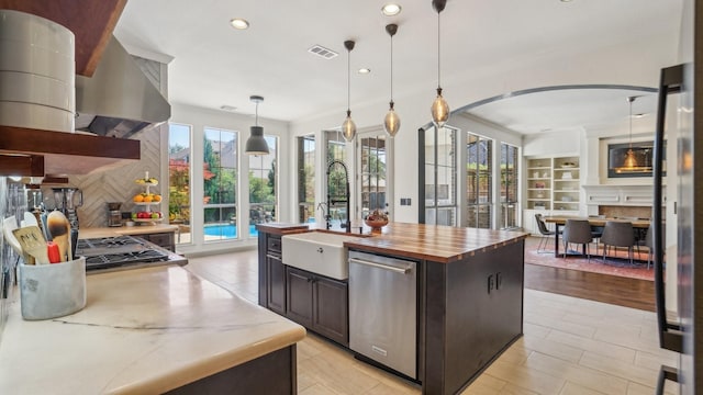 2026 Spindletop Trl, Frisco, TX 75033 - kitchen with stainless steel dishwasher, a sink, recessed lighting, dark brown cabinets, and backsplash