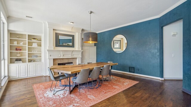 2026 Spindletop Trl, Frisco, TX 75033 - dining space featuring crown molding, a large fireplace, wood finished floors, baseboards, and built in features