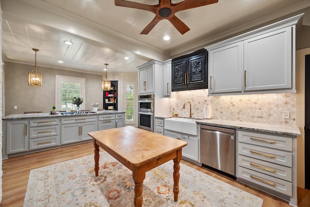 1111 Governors Dr, Corsicana, TX 75110 - kitchen with stainless steel appliances, a sink, light wood-type flooring, tasteful backsplash, and crown molding