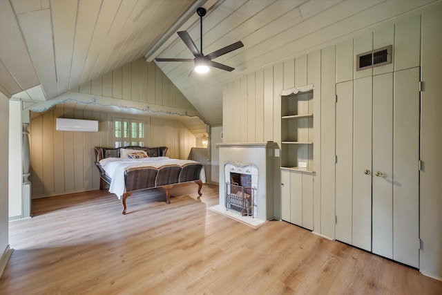 1111 Governors Dr, Corsicana, TX 75110 - bedroom with wood finished floors, a wall mounted AC, wood walls, a fireplace, and ceiling fan