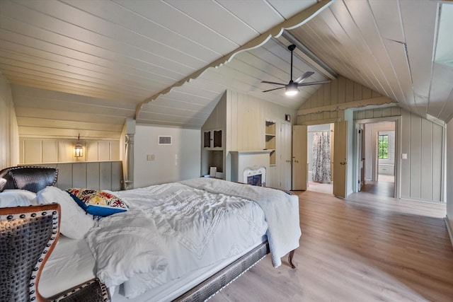 1111 Governors Dr, Corsicana, TX 75110 - bedroom featuring vaulted ceiling, wooden walls, and wood finished floors