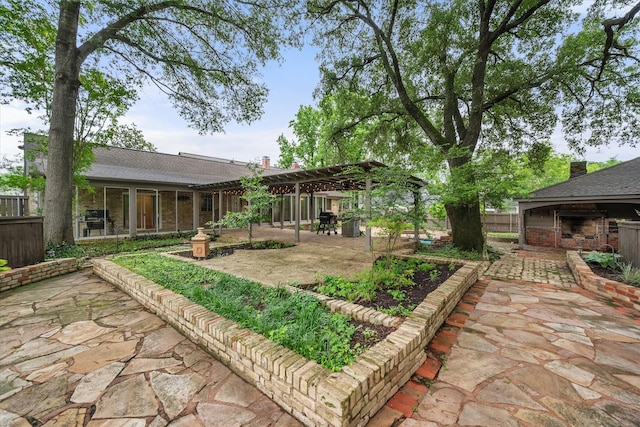 1111 Governors Dr, Corsicana, TX 75110 - fenced backyard with exterior fireplace, a patio, and a pergola