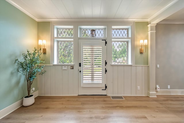 1111 Governors Dr, Corsicana, TX 75110 - doorway with ornamental molding, wood finished floors, plenty of natural light, and ornate columns
