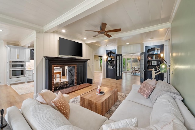 1111 Governors Dr, Corsicana, TX 75110 - living room with crown molding, wood finished floors, a multi sided fireplace, ceiling fan, and recessed lighting