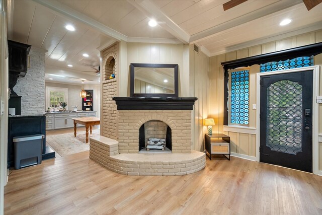 1111 Governors Dr, Corsicana, TX 75110 - entrance foyer featuring wood finished floors, a brick fireplace, ornamental molding, a ceiling fan, and recessed lighting