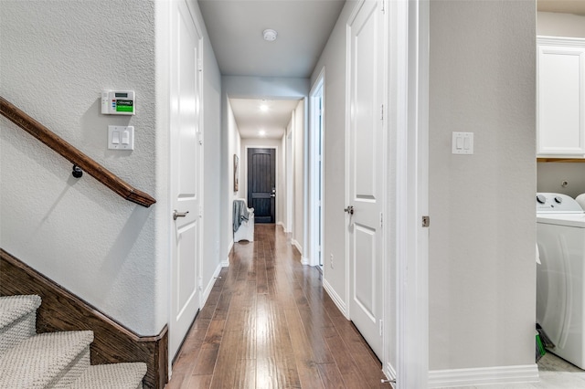 corridor with washer / dryer, hardwood / wood-style flooring, and a textured wall