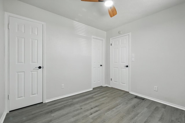 2755 Harbinger Ln, Dallas, TX 75287 - unfurnished bedroom with wood finished floors, baseboards, and ceiling fan