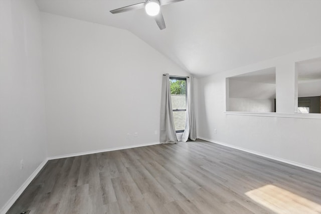 2755 Harbinger Ln, Dallas, TX 75287 - empty room with lofted ceiling, a ceiling fan, wood finished floors, and baseboards