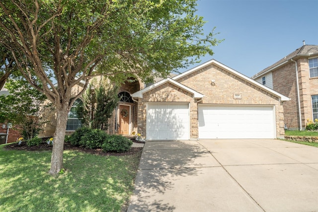 10149 Red Bluff Ln, Fort Worth, TX 76177 - view of front of property with a garage, concrete driveway, a front yard, and brick siding