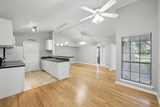 4620 Carr St, The Colony, TX 75056 - kitchen featuring dark countertops, ceiling fan, a peninsula, open floor plan, and white cabinets