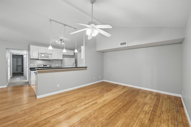 4620 Carr St, The Colony, TX 75056 - kitchen with white appliances, lofted ceiling, white cabinets, ceiling fan, and baseboards