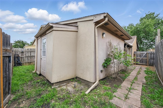 4620 Carr St, The Colony, TX 75056 - view of side of home featuring stucco siding and a fenced backyard