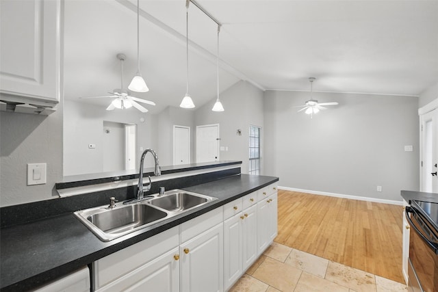 4620 Carr St, The Colony, TX 75056 - kitchen featuring a ceiling fan, a sink, stove, dark countertops, and vaulted ceiling