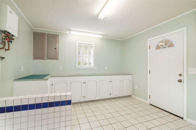 321 Evangeline Dr, Elm Grove, LA 71051 - kitchen with a textured ceiling, crown molding, white cabinetry, water heater, and electric panel