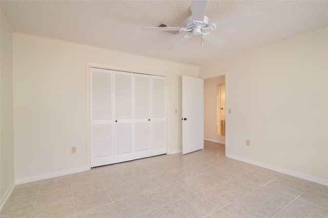 321 Evangeline Dr, Elm Grove, LA 71051 - unfurnished bedroom featuring a closet, a textured ceiling, a ceiling fan, light tile patterned flooring, and baseboards