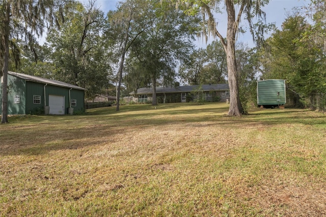 321 Evangeline Dr, Elm Grove, LA 71051 - view of green lawn featuring a detached garage and an outdoor structure