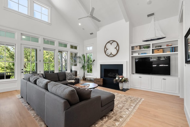 4525 E Cove Ct, Malakoff, TX 75148 - living room with high vaulted ceiling, light wood-style flooring, a ceiling fan, and a fireplace with flush hearth