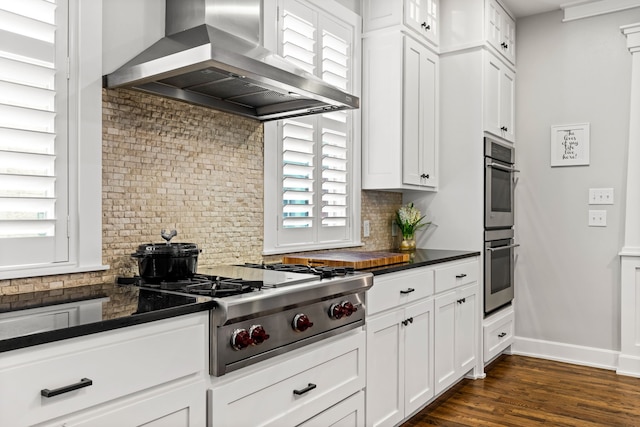4144 Emerson Ave Unit 2, University Park, TX 75205 - kitchen featuring wall chimney range hood, stainless steel appliances, dark countertops, and decorative backsplash