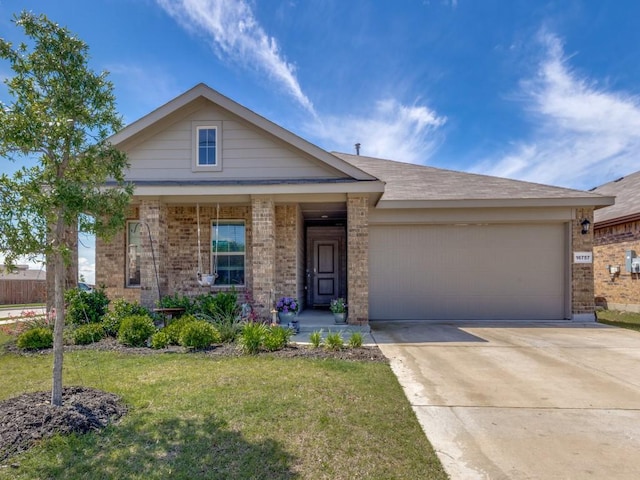 16757 Portage St, Justin, TX 76247 - view of front facade featuring brick siding, a front lawn, a garage, and concrete driveway
