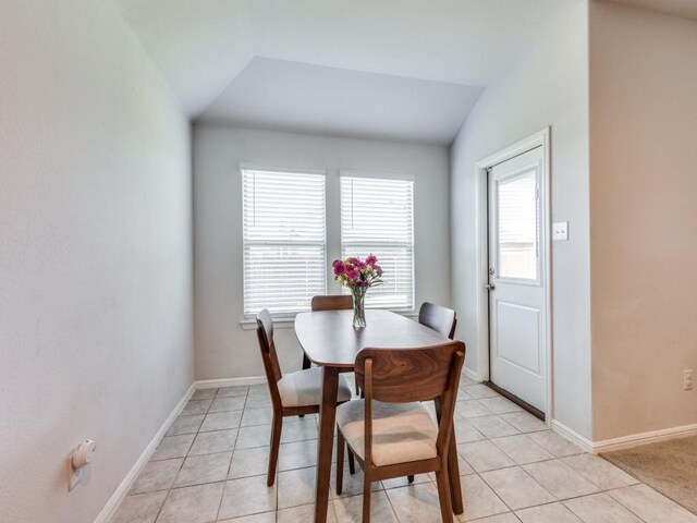 16757 Portage St, Justin, TX 76247 - dining room with vaulted ceiling, light tile patterned floors, and baseboards