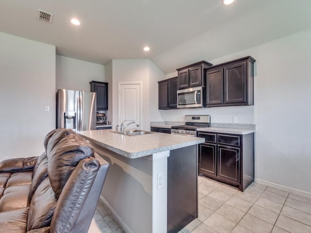 16757 Portage St, Justin, TX 76247 - kitchen featuring appliances with stainless steel finishes, a sink, light countertops, recessed lighting, and a kitchen island with sink