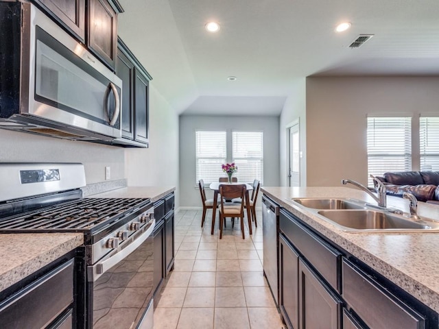 16757 Portage St, Justin, TX 76247 - kitchen with stainless steel appliances, a sink, recessed lighting, light countertops, and light tile patterned floors
