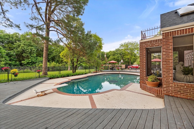 view of swimming pool featuring a fenced backyard, a deck, and a patio area