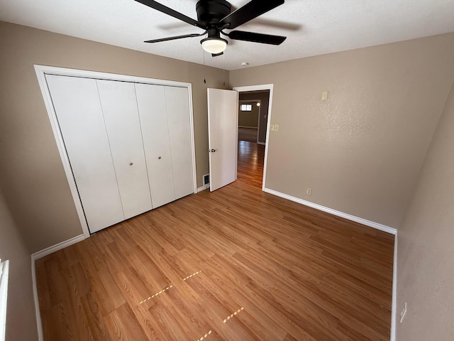 2325 S 40th St, Abilene, TX 79605 - unfurnished bedroom with light wood-style flooring, baseboards, a closet, and a ceiling fan