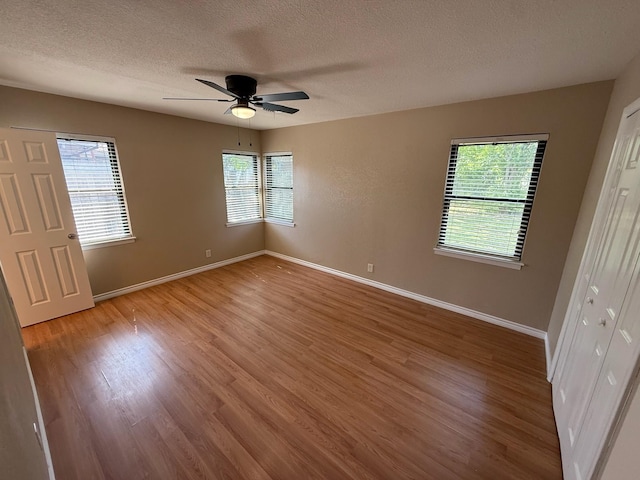 2325 S 40th St, Abilene, TX 79605 - unfurnished bedroom with a textured ceiling, multiple windows, and baseboards