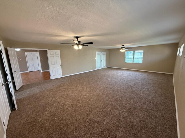2325 S 40th St, Abilene, TX 79605 - unfurnished room featuring a ceiling fan, dark colored carpet, baseboards, healthy amount of natural light, and a textured ceiling