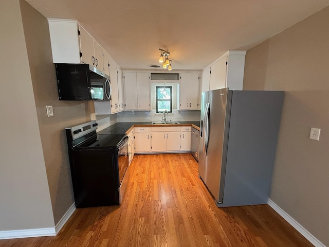 2325 S 40th St, Abilene, TX 79605 - kitchen featuring appliances with stainless steel finishes, light wood finished floors, and decorative backsplash