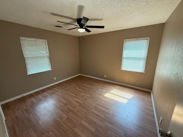 2325 S 40th St, Abilene, TX 79605 - spare room featuring wood finished floors, a textured ceiling, a ceiling fan, and baseboards
